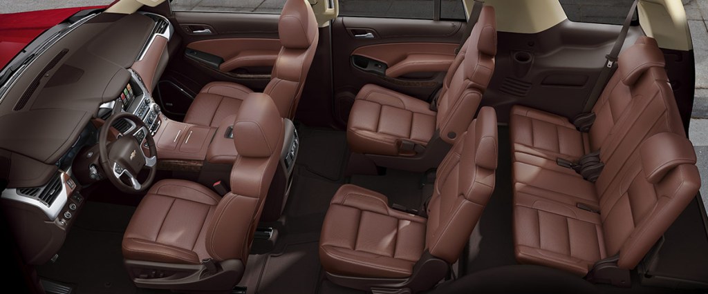 A 2018 Tahoe with brown leather seats.