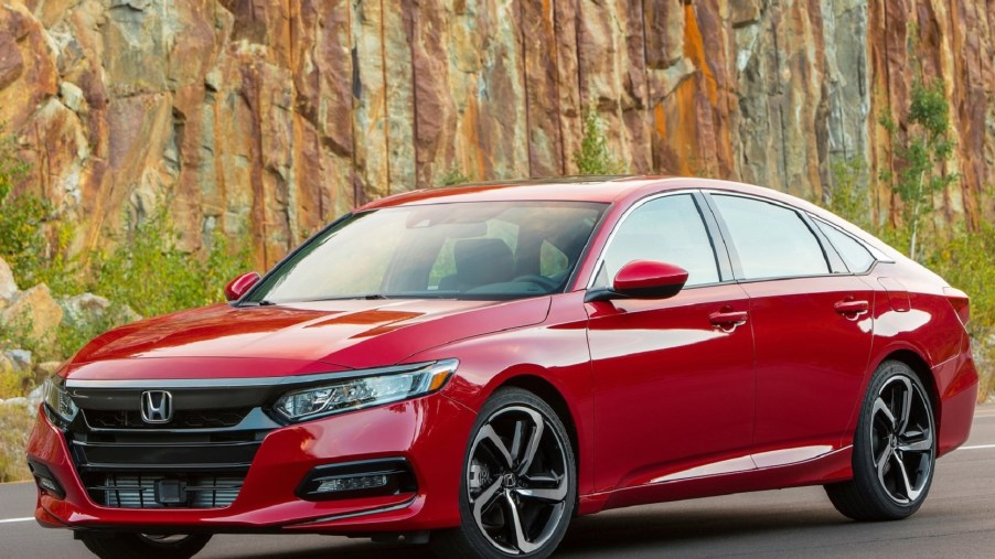 A red 2020 Honda Accord 2.0T Sport by a rocky hill