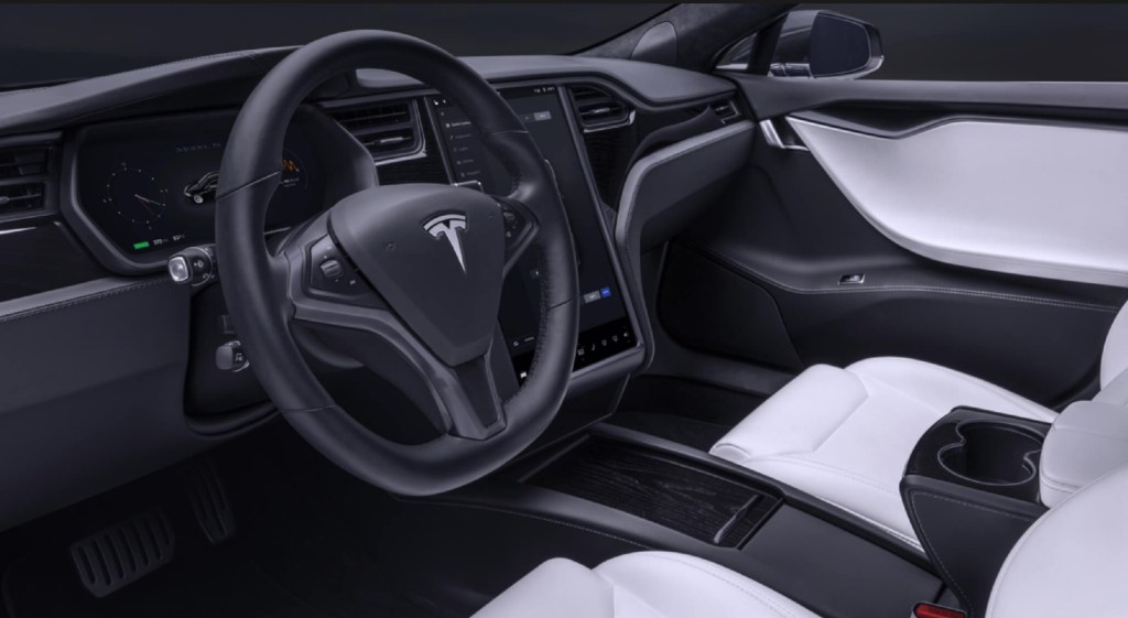 The 2020 Tesla Model S' white front seats, black dashboard, and central screen