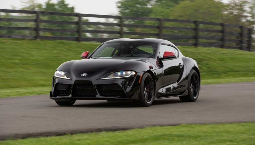 An image of a Toyota Supra driving down the street.