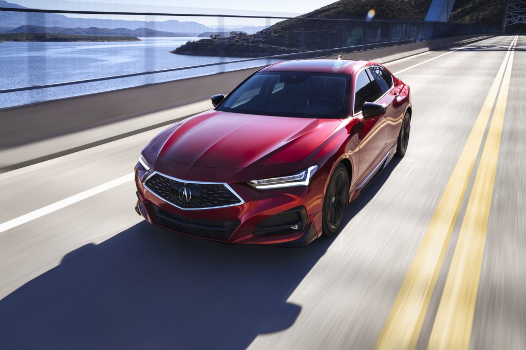 A red 2021 Acura TLX driving down a highway