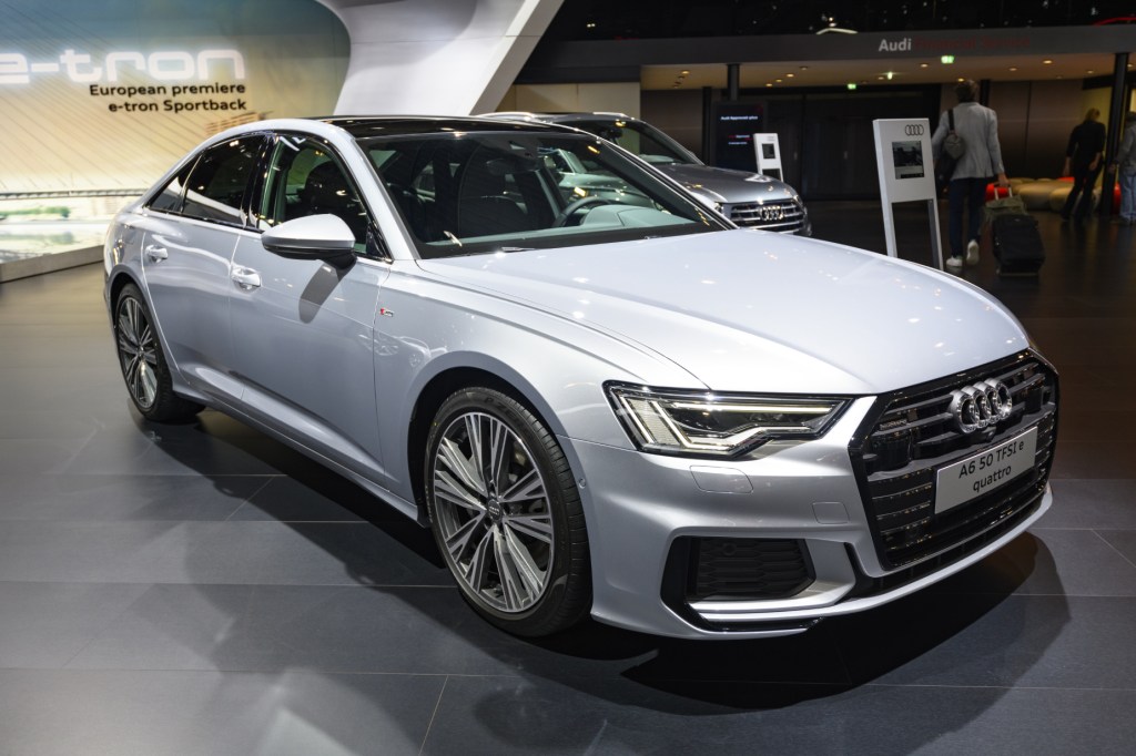 A white 2021 Audi A6 on display at an auto show