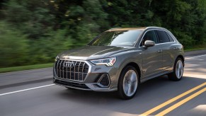 A silver 2021 Audi Q3 driving down a highway street