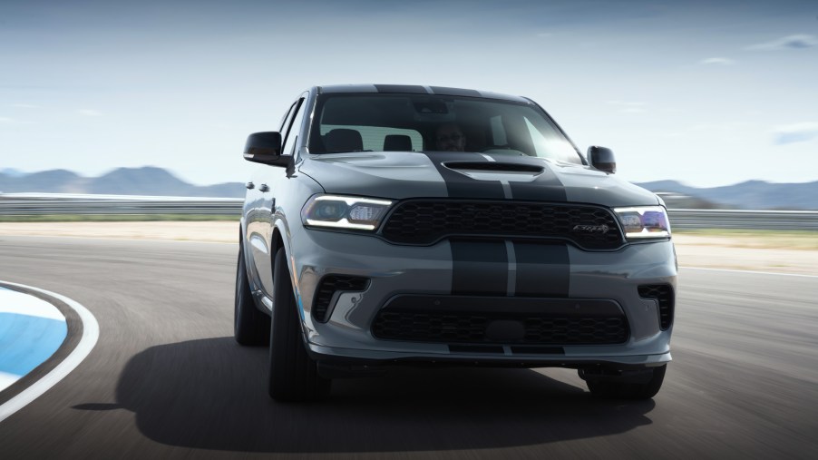 A silver and black 2021 Dodge Durango Hellcat driving on a track
