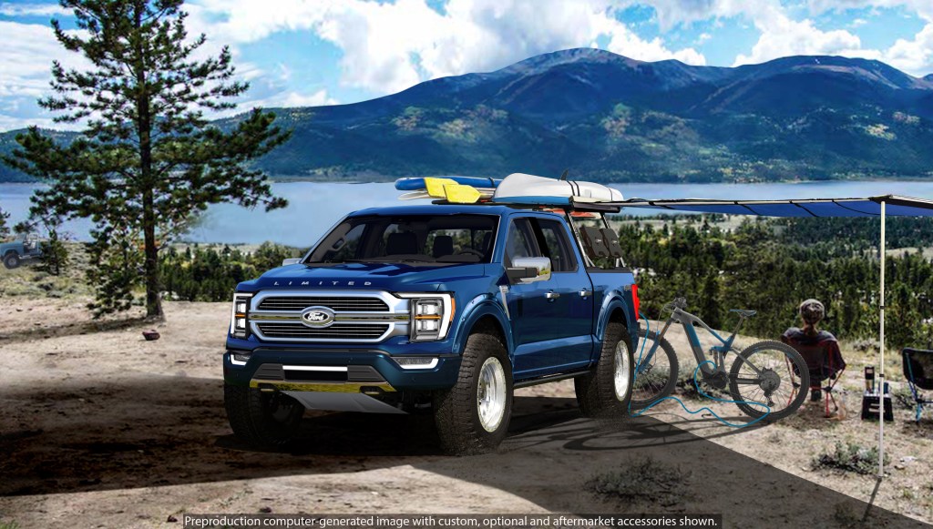 The blue 2021 Ford F-150 Limited Hybrid SuperCrew by BDS Suspension next to a mountain lake