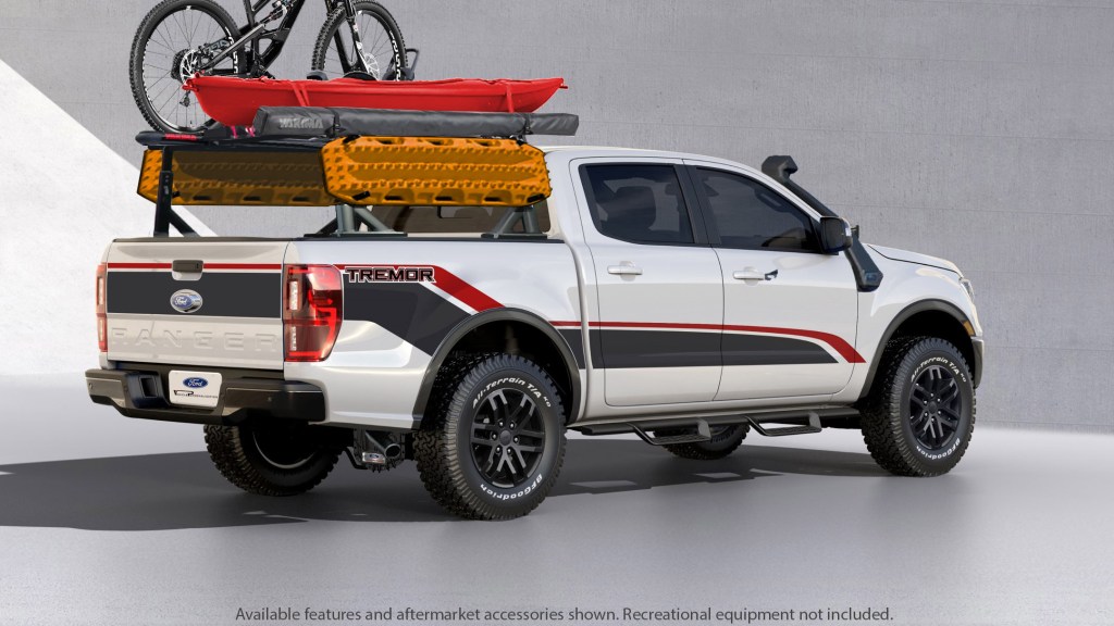 The rear 3/4 view of a white-black-and-red 2021 Ford Ranger XLT Tremor SuperCrew modified for SEMA