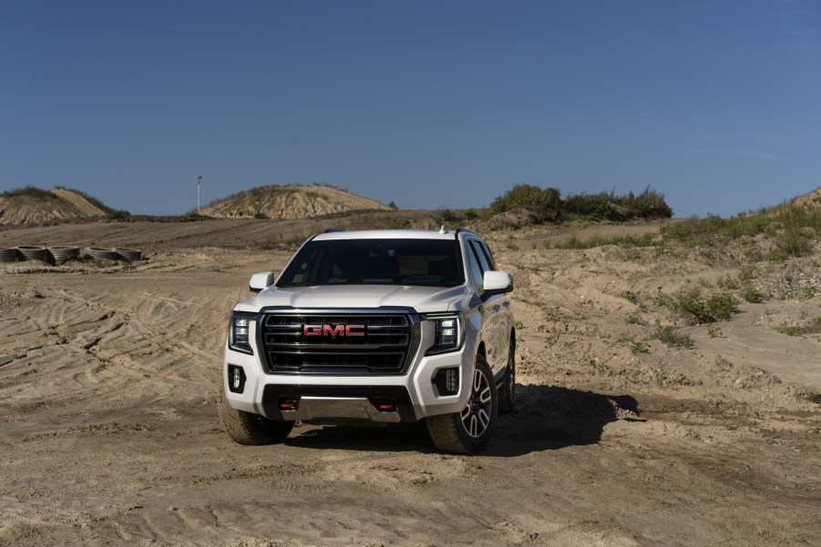 A 2021 GMC Yukon AT4 driving on sandy terrain