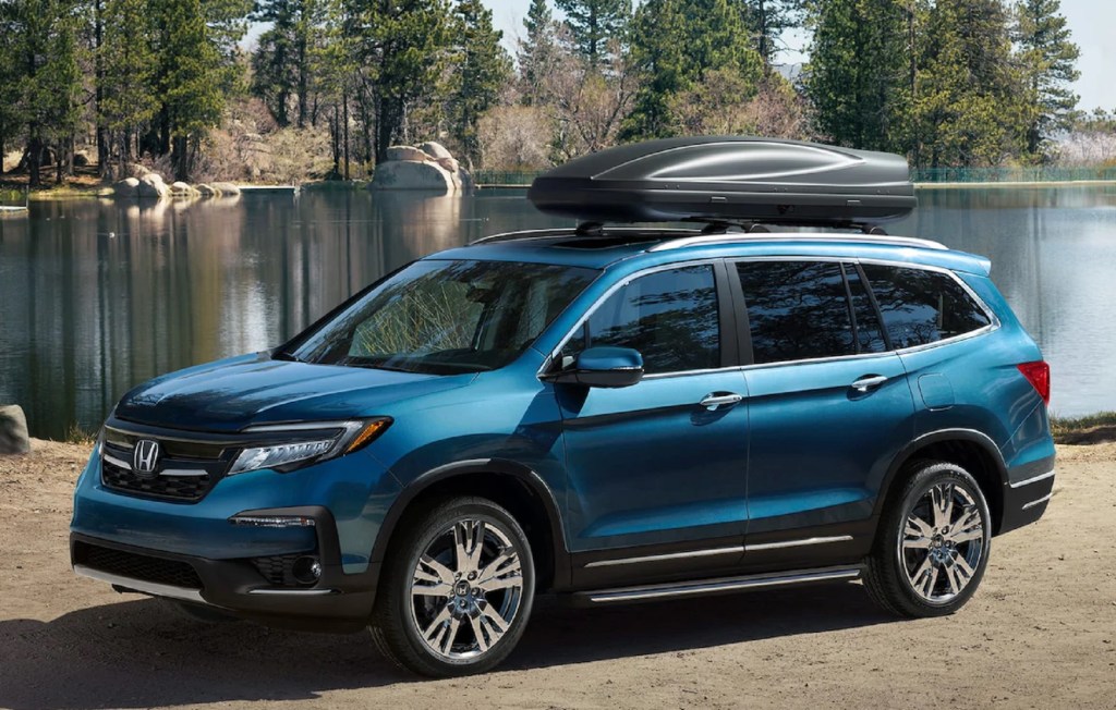 A blue 2021 Honda Pilot Elite with a roof box