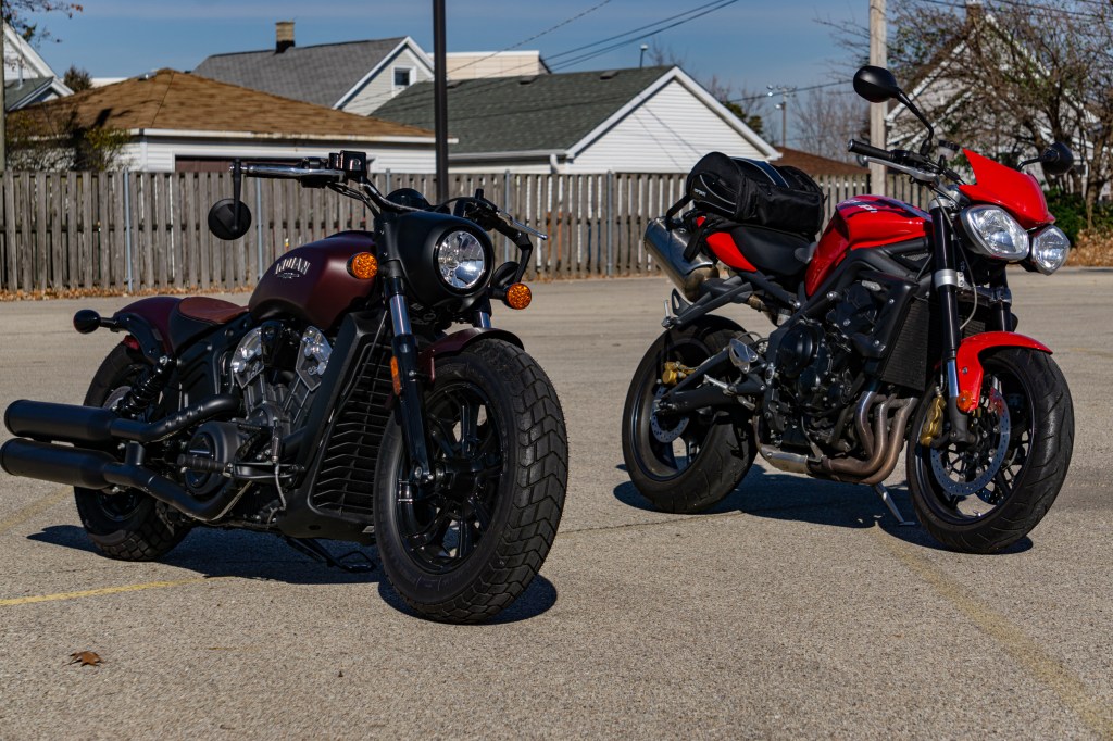 A maroon 2021 Indian Scout Bobber next to a red 2012 Triumph Street Triple R