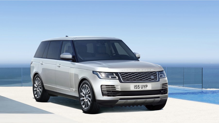 A silver 2021 Range Rover on display with a blue sky background