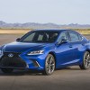 A blue 2021 Lexus ES on display with a mountain range in the background