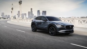 A silver 2021 Mazda CX-30 driving on a highway