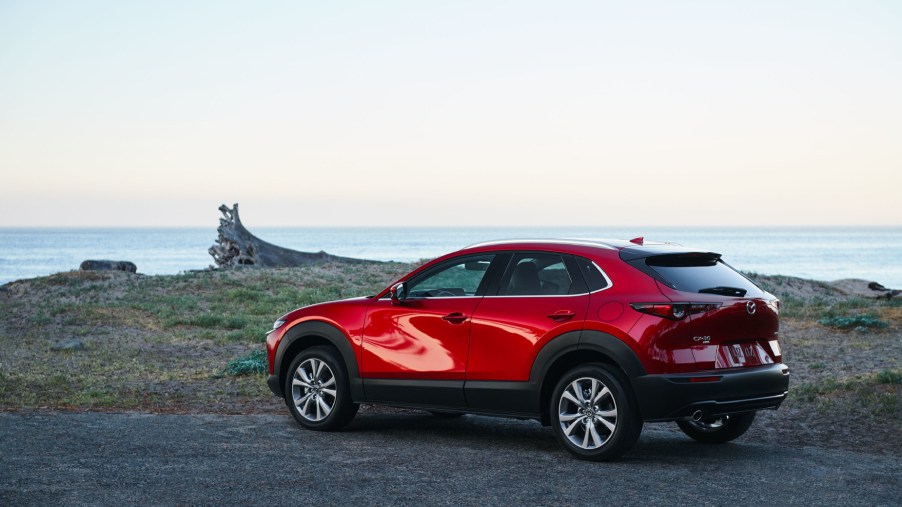 A red 2021 Mazda CX-30 parked near the ocean