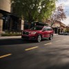 A red 2021 Subaru Ascent driving down a city street