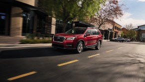 A red 2021 Subaru Ascent driving down a city street