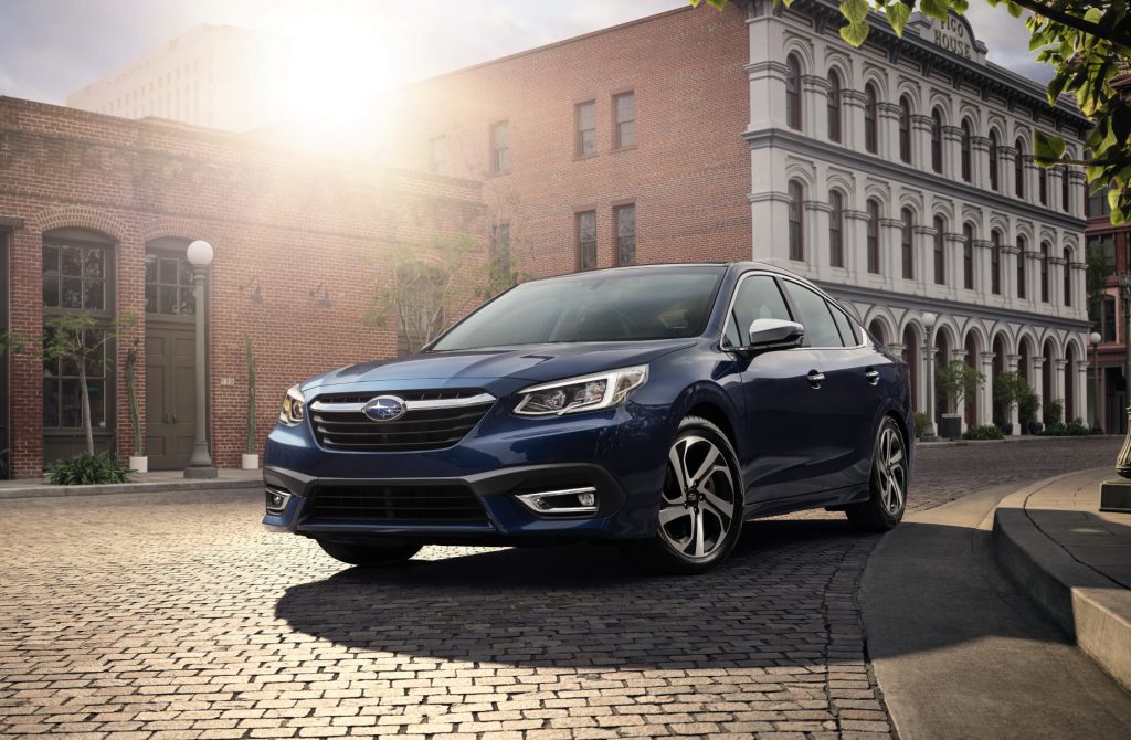 A blue 2021 Subaru Legacy sedan parked in a city shows a sedan that's ranked high for safety