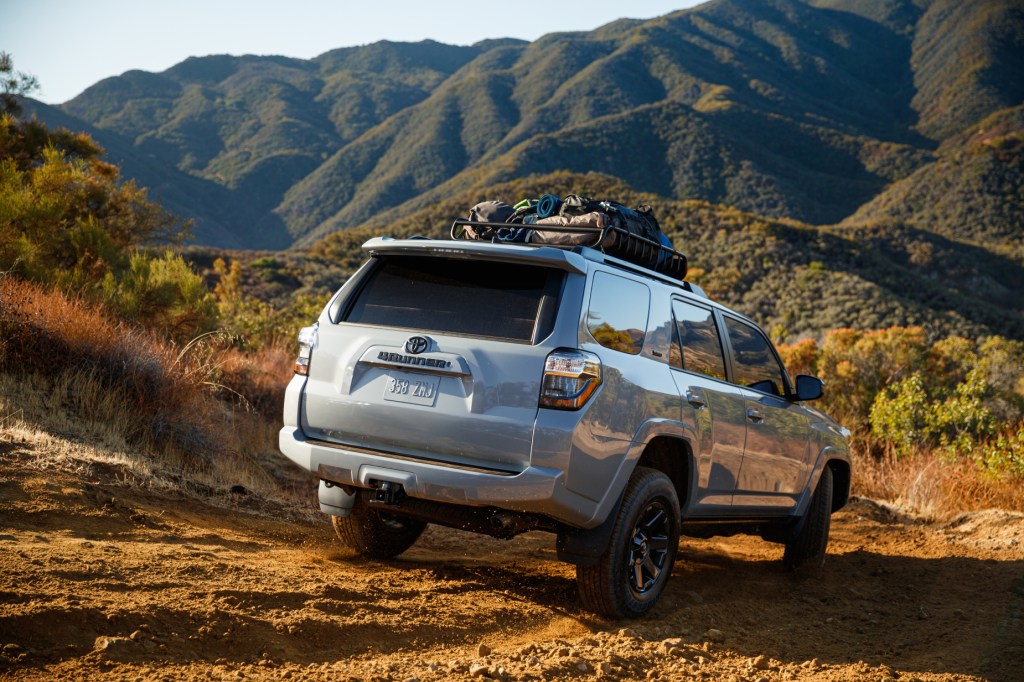 A silver 2021 Toyota 4Runner driving on rugged terrain