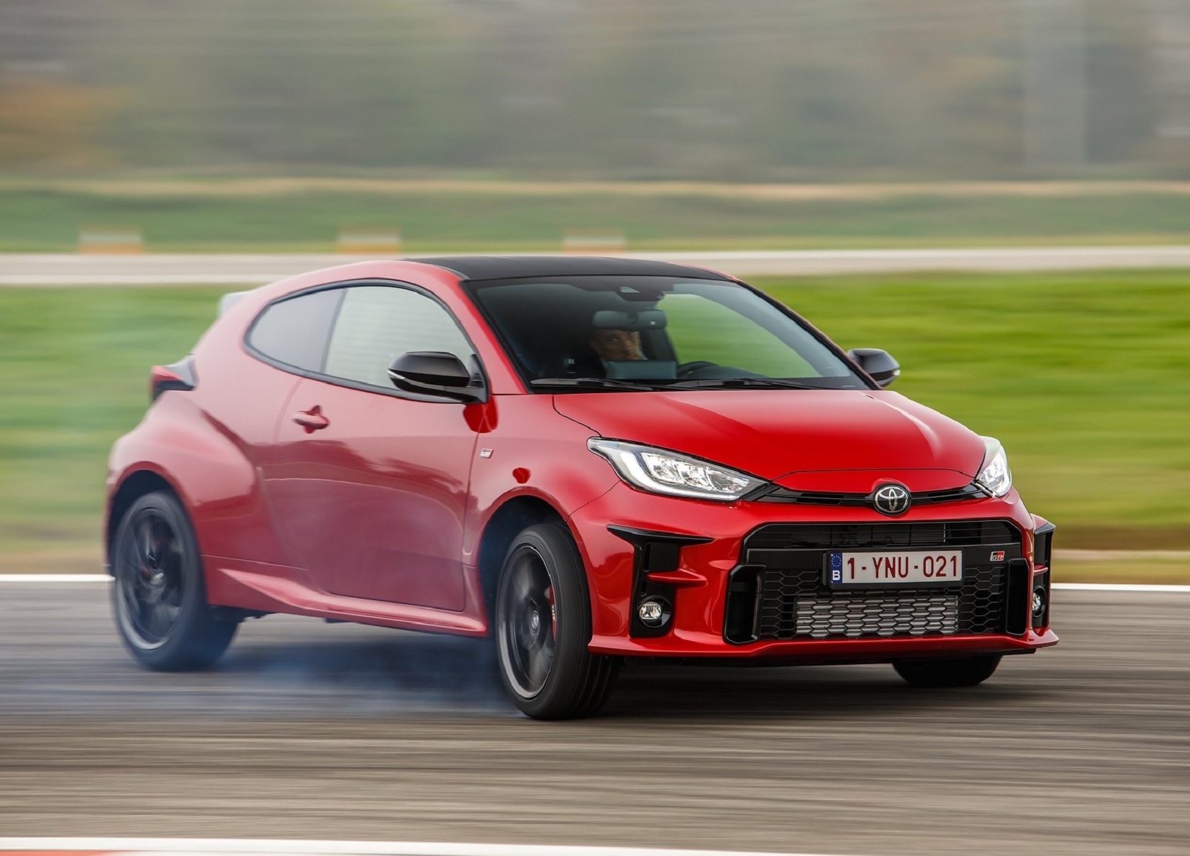 A red 2021 Toyota GR Yaris slides on a track