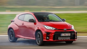 A red 2021 Toyota GR Yaris slides on a track