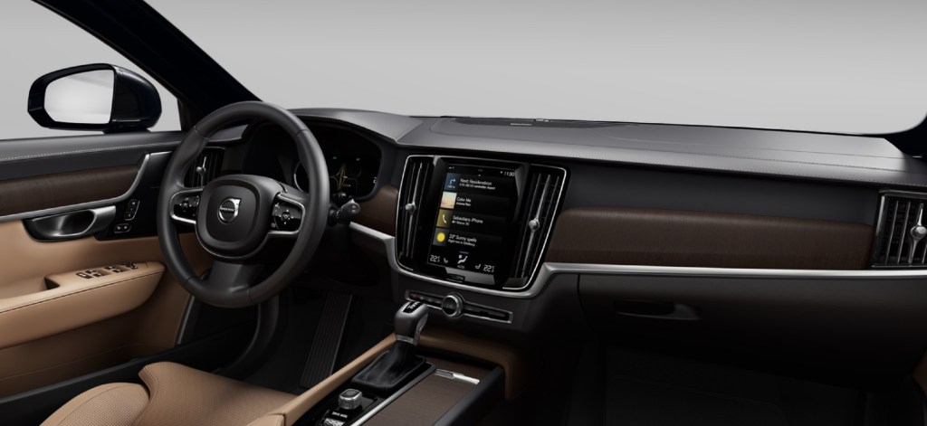 The tan-leather front seats and walnut dashboard of the 2021 Volvo V90 T6 Inscription