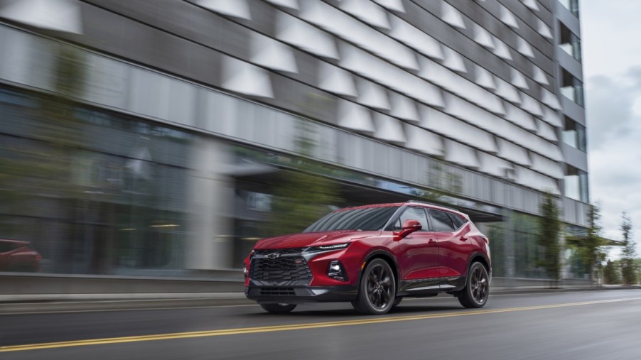2021 red Chevy Blazer on road near large office building