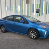 An electric blue 2021 Toyota Prius parked on the street.
