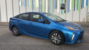 An electric blue 2021 Toyota Prius parked on the street.