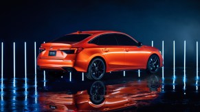 A orange 2022 Honda Civic prototype on display during the car's reveal