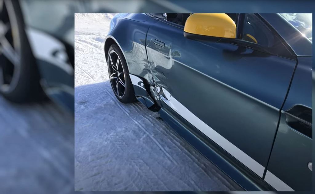 Damage to an Aston Martin's rear 3/4 panel.