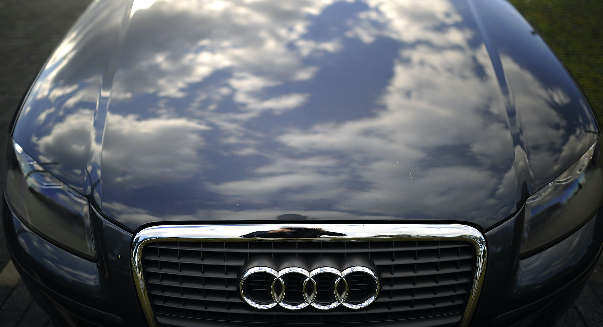 Clouds reflected on the hood of a parked Audi A3