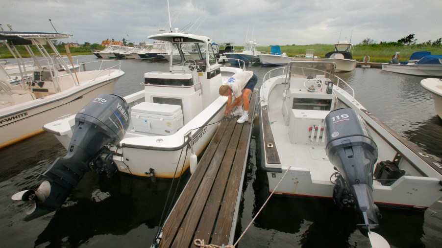 Two boats tied up a dock