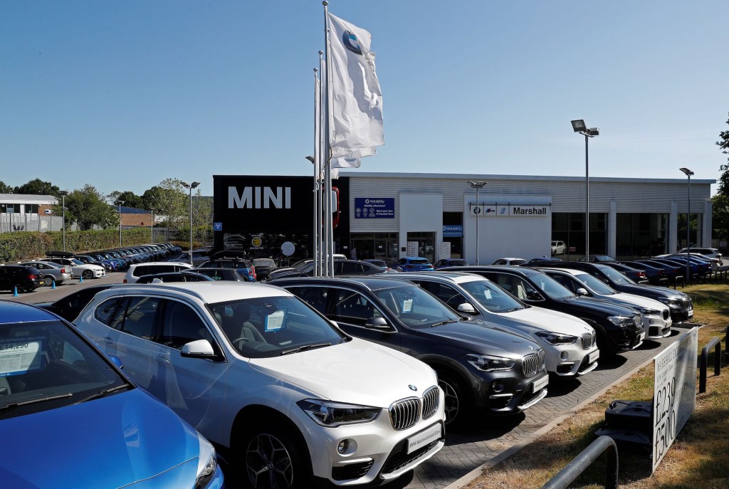 New and used cars are pictured on the forecourt at a re-opened BMW car dealership, in Hook, southwest of London, following the easing of the lockdown restrictions during the novel coronavirus COVID-19 pandemic