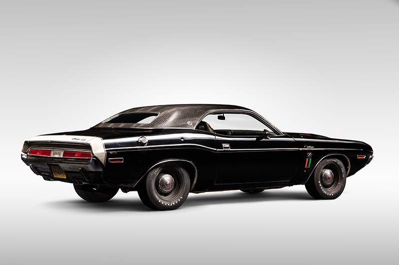 A photo of a 1970 Dodge Challenger in a photo studio.