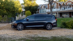 A black 2021 Chrysler Pacifica parked in front of a house