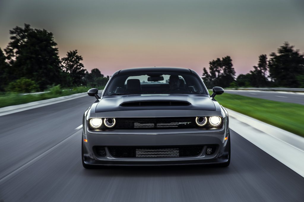 A photo of the 2018 Dodge Challenger SRT Demon driving through a city.