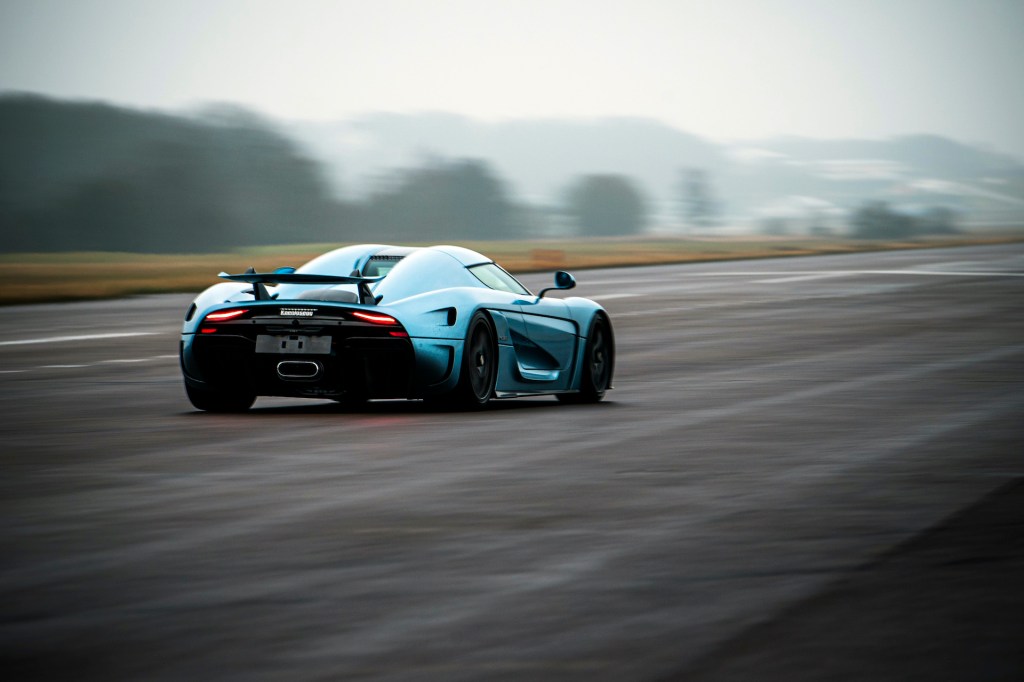 An image of a Koenigsegg Regera speeding down a runway.