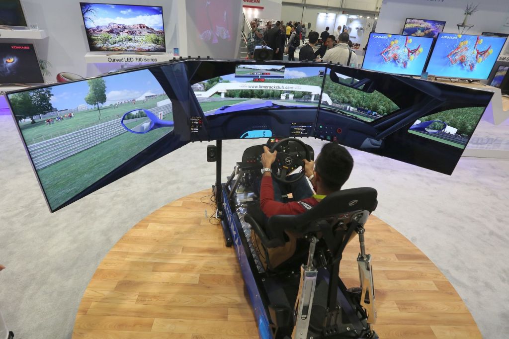An image of someone playing a racing game with a simulator.