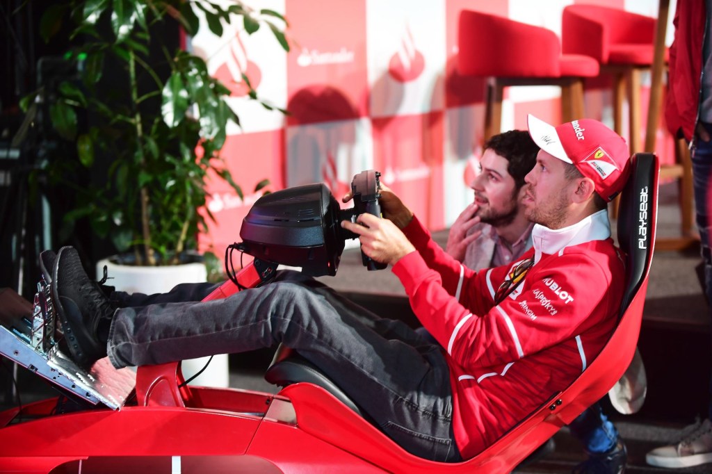 An image of someone playing a racing game with a simulator.