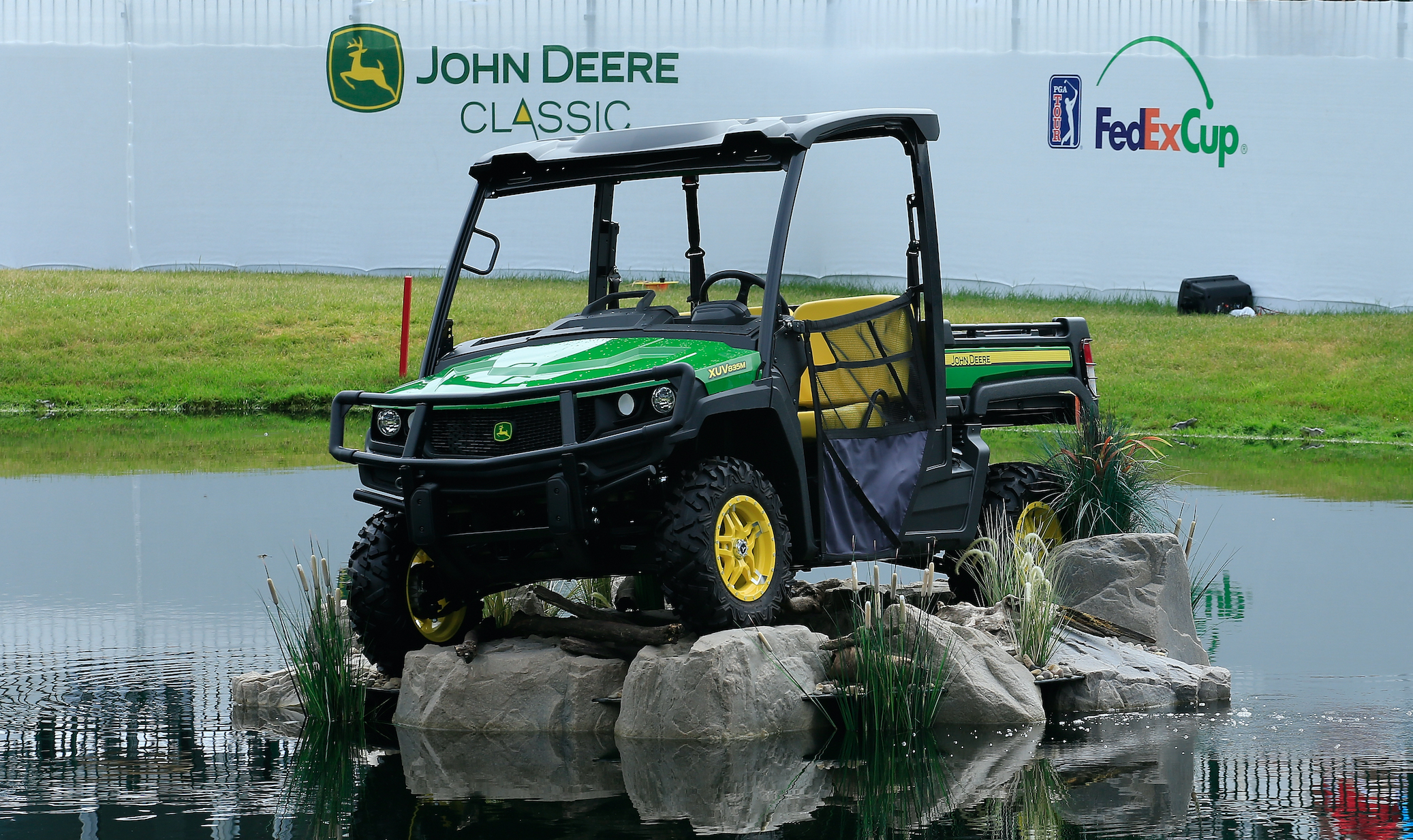 A John Deere Gator vehicle is seen adjacent to the 18th green during the fourth and final round of the John Deere Classic
