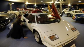 A white Lamborghini Countach is on display at an indoor show.