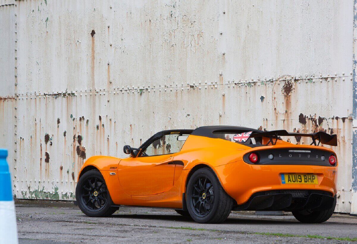 An orange Lotus Elise shows off its prominent rear wing.