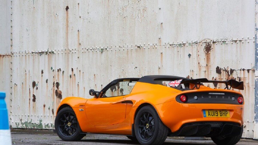 An orange Lotus Elise shows off its prominent rear wing.