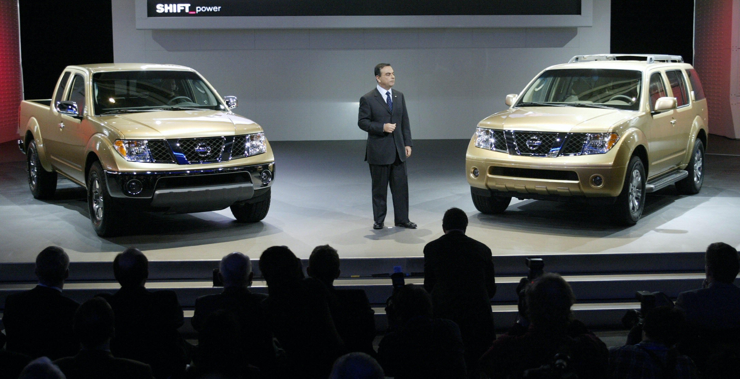 Carlos Ghosn, President and CEO of Nissan Motor Company introduces the new 2005 Frontier (L) and Pathfinder (R) during the press days 05 January 04 at the North American International Auto Show