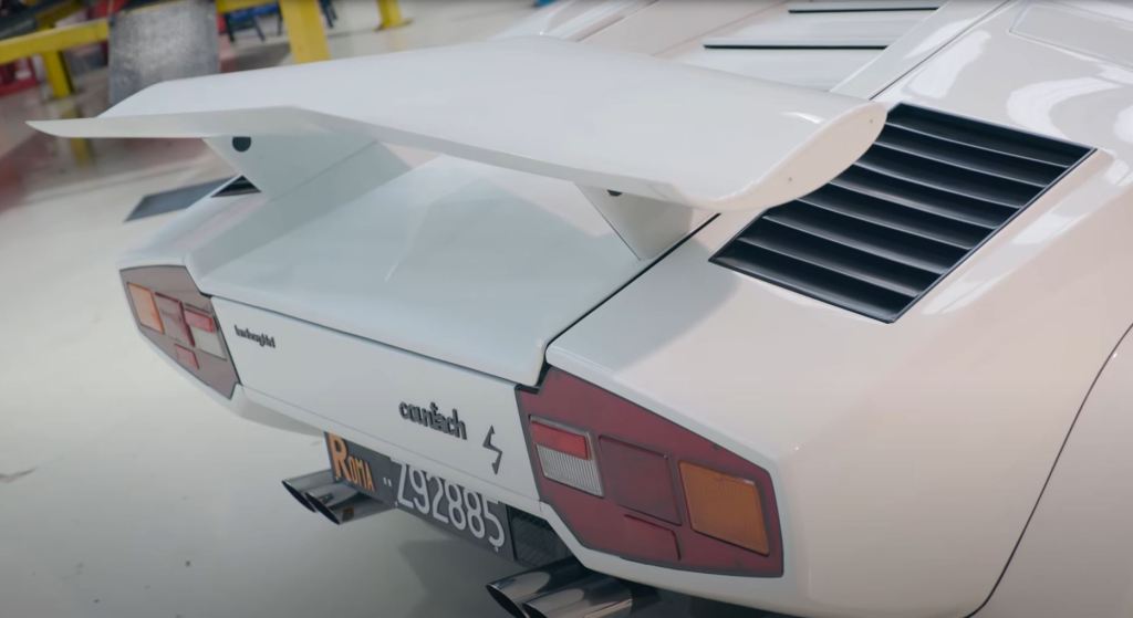 The rear of a 1980 Lamborghini Countach with its prominant spoiler.