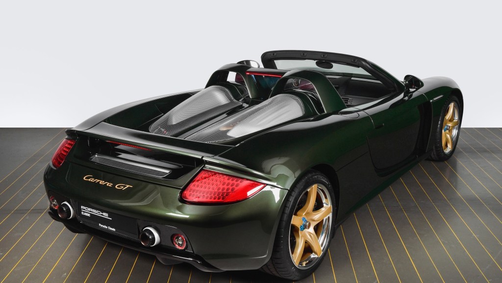 A dark-green Porsche Carrera GT restored by Porsche Classic