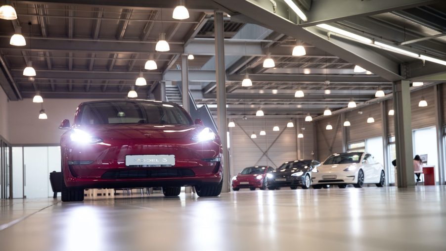 A Tesla Model 3 (l) and other Tesla models are on display in the new Tesla Service Center