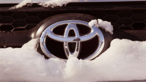 A Toyota logo seen on a snow covered SUV