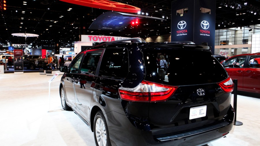 A black Toyota Sienna on display at an auto show