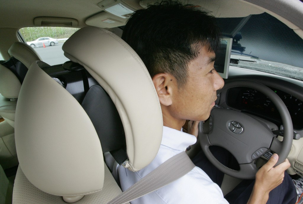 man using car headrest