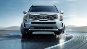 A chrome 2021 new Kia Telluride navigating in water.